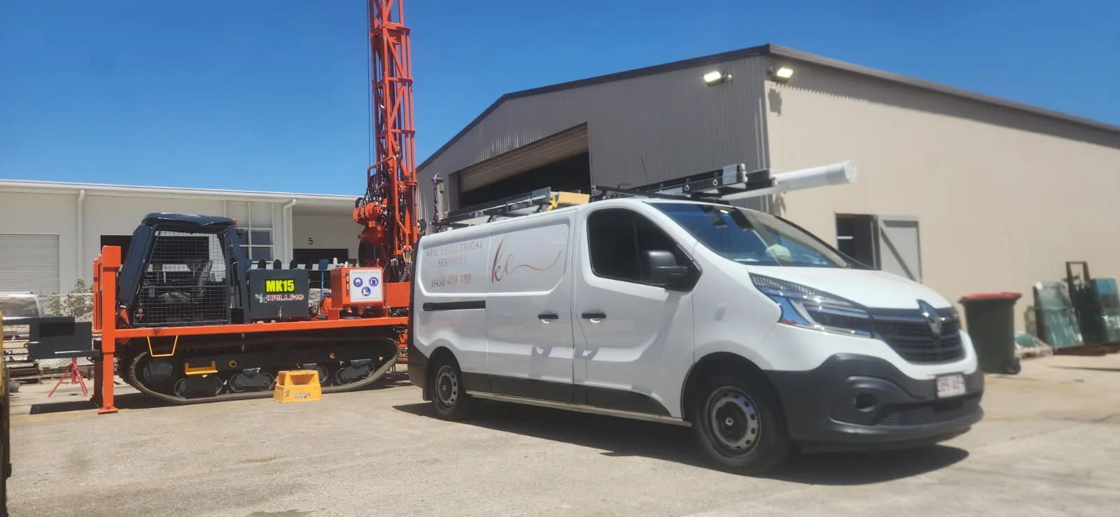 Keil's Electrical Services van, white with the rose-gold ke logo, parked on site in an industrial yard